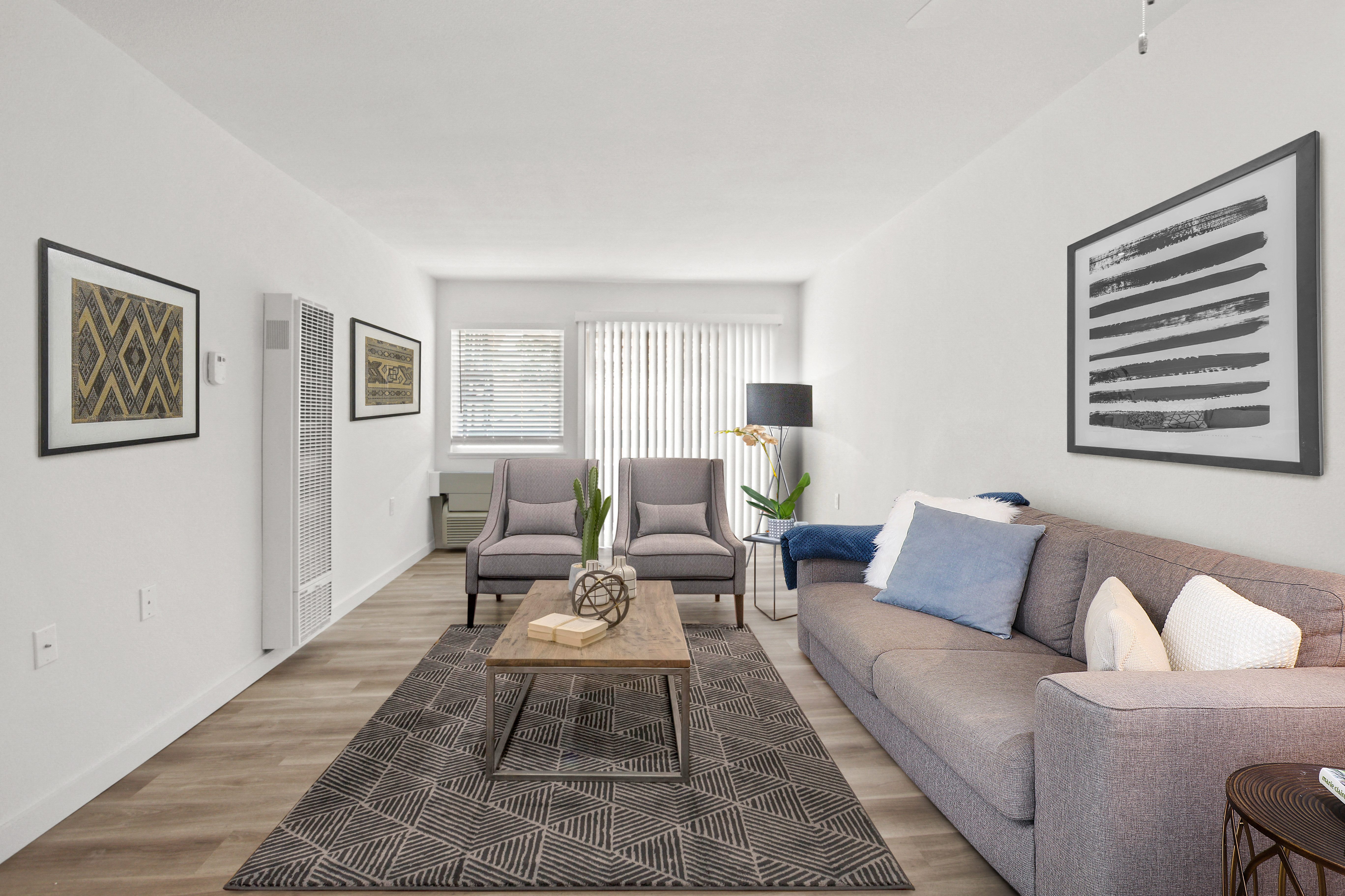 a living room with a gray couch and two gray chairs at Harvard Manor, Irvine, CA